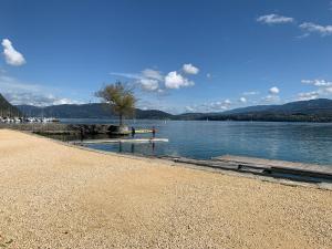 a beach next to a body of water at ANNEXE du LAC in Le Bourget-du-Lac