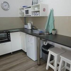 a small kitchen with a counter and a sink at Rose and Ale Self Catering Units in Gonubie