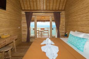 a bedroom with a bed with towels on it at The Dewi Sun Sun Nusa Penida in Nusa Penida