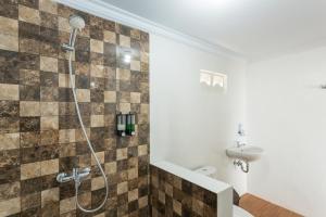 a bathroom with a shower and a sink at The Dewi Sun Sun Nusa Penida in Nusa Penida +45 photos
