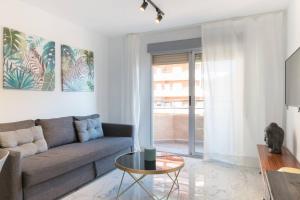 a living room with a couch and a table at Apartamento Puertoplaya II in Puerto de Mazarrón