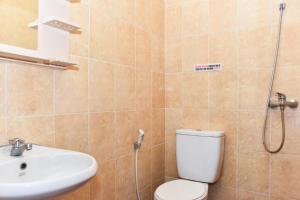a bathroom with a toilet and a sink at RedDoorz near Lenmarc Mall Surabaya in Pradahkalikendal