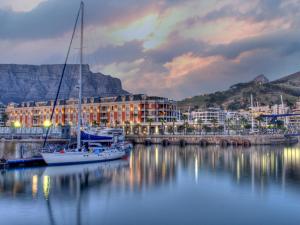 a marina with a sail boat in the water at Cape Grace, A Fairmont Managed Hotel in Cape Town