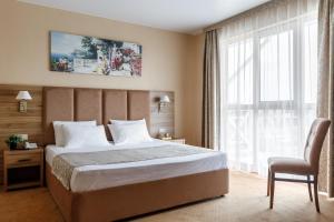 a hotel room with a bed and a window at LetooteL Hotel in Blagoveshchenskaya