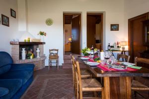 a living room with a table and a blue couch at BORGO MONTEMAGGIORE in Rapolano Terme +36 photos