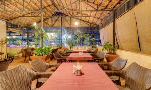 a restaurant with a red table and chairs at Treebo Terminus, Koramangala 5th Block in Bangalore +37 photos