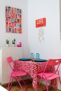 a dining room with pink chairs and a table at Cozy Studio near Downtown in Heraklio