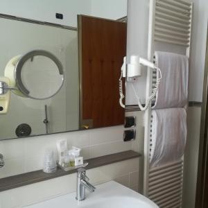 a bathroom with a sink and a mirror at Hotel Bristol in Milan