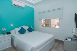 Postel nebo postele na pokoji v ubytování Glow Inn Siem Reap