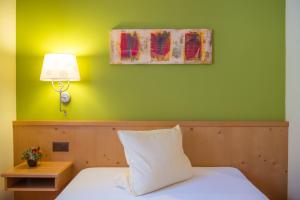 Letto o letti in una camera di Hotel La Cruna