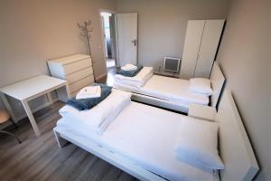 a small room with two beds and a desk at Centrum Żeglarskie Domki Kempingowe in Szczecin