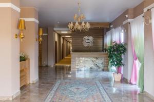 a hallway of a hotel with a fireplace and a chandelier at LetooteL Hotel in Blagoveshchenskaya