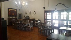 a dining room with chairs and a table and a table and chairsktop at 93 on Celliers Guesthouse in Louis Trichardt