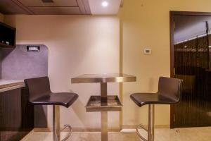 a bar with two chairs and a table at Sai Palace Grand, Malad in Mumbai