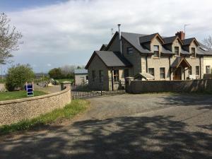 a large house with a fence in front of it at Portrush/ballyhome in Portrush