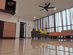 a living room with a couch and a ceiling fan at Petaling Jaya Atria Sofo Suite in Petaling Jaya