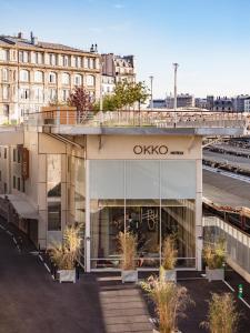a train station with a train on the tracks at OKKO Hotels Paris Gare de l'Est in Paris
