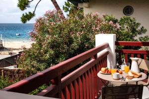 a table with fruit on a balcony with the beach at Villa du Pyla in Pyla-sur-Mer +32 photos