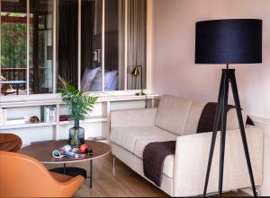 a living room with a couch and a lamp at Villa du Pyla in Pyla-sur-Mer