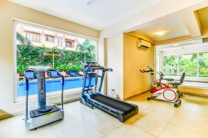 a gym with two exercise bikes and a treadmill at Veera Strand Park Serviced Apartments near Calangute in Calangute