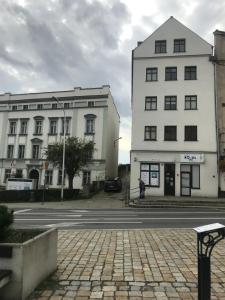 a person walking in front of two buildings at Apartament Centrum in Świdnica