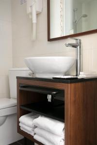 a bathroom with a sink and towels on a counter at Montparnasse Alésia in Paris