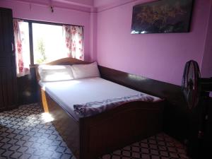 Tempat tidur dalam kamar di City View Home Stay