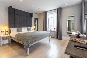 a bedroom with a large bed and a desk at The Inn on the Mile in Edinburgh