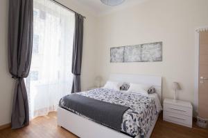 a bedroom with a bed and a large window at Guest House Rita in La Spezia
