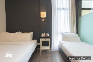 Postel nebo postele na pokoji v ubytování Ceria Hotel