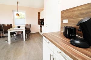 a kitchen with a desk with a computer mouse on a counter at Ferienhaus Wis mit Sauna in Ostseebad Karlshagen