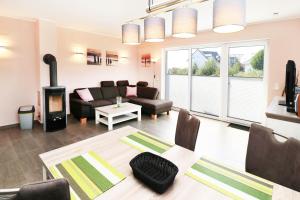 a living room with a couch a table and a fireplace at Ferienhaus Wis mit Sauna in Ostseebad Karlshagen