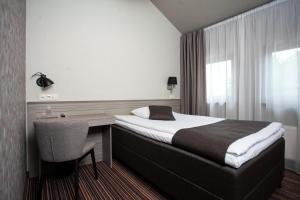Säng eller sängar i ett rum på Hotel Cēsis