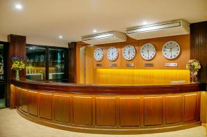 a waiting room with clocks on the wall at Buritel Hotel in Buriram