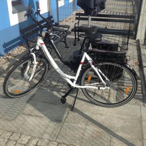 a bike parked on a sidewalk next to a bench at Casa del Mar free Parking Only Adults for Young U45yrs in Międzyzdroje