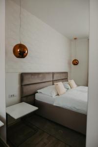 En eller flere senge i et værelse på Hotel Patria