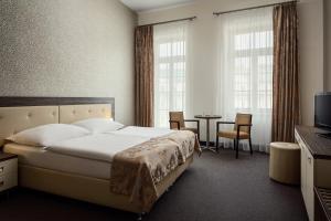 Łóżko lub łóżka w pokoju w obiekcie Hotel Malta