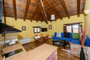 Casa rural Lo Regolfo في La Codoñera: غرفة معيشة مع أريكة زرقاء وطاولة