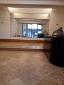 a man sitting at a desk in an empty room at Copacabana apartment with a living room and 2 sleeping rooms in Rio de Janeiro