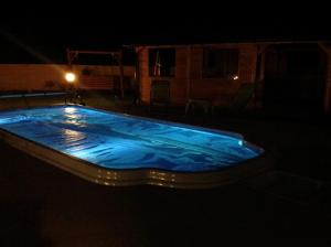 a large swimming pool lit up at night at VILLA DANIELA II in Sieciemin