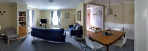 a living room with a table and a dining room at Steps to the Waterfront in Shelburne