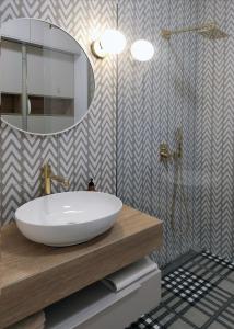 a bathroom with a white sink and a mirror at Come&Stay apartments Wola in Warsaw