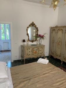 a white room with a dresser and a mirror at Venice San Leonardo in Venice