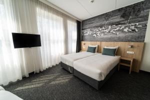 Een bed of bedden in een kamer bij Hotel De Bonte Wever Assen