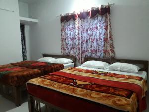 Postelja oz. postelje v sobi nastanitve Munnar Brindavan Cottage