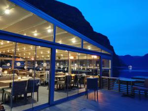 a restaurant with tables and chairs at night at Flåm Marina in Flåm