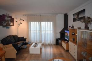 a living room with a couch and a coffee table at BEACH HOUSE. CASA CON PISCINA PRIVADA in Calafell