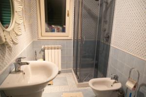 a bathroom with a sink and a shower at Ninfa Apartment - Taormina Holidays in Taormina +10 photos