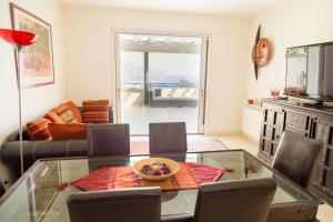 a living room with a glass table and a couch at Ninfa Apartment - Taormina Holidays in Taormina