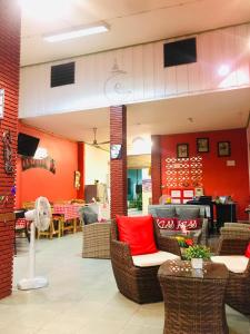 a restaurant with red walls and wicker chairs at Plaza Huahin in Hua Hin +36 photos